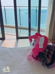 Size: 3082x4109 | Tagged: safe, derpibooru import, pinkie pie, pony, g4, bedroom, chinese, clothes, curtains, door, dress, indoors, irl, lying down, merchandise, ocean, official, outfit, photo, plushie, pony plushie, rear view, reesee, solo, water