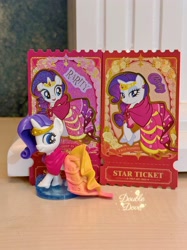 Size: 2750x3667 | Tagged: safe, derpibooru import, rarity, pony, unicorn, g4, card, clothes, crown, double dove, dress, ear piercing, earring, figure, gala dress, grand galloping gala, horn, indoors, irl, jewelry, kayou, looking back, merchandise, official, open mouth, outfit, photo, piercing, regalia, shoes, text, toy