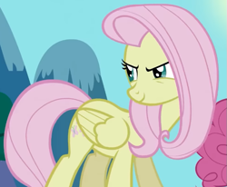 Size: 683x562 | Tagged: safe, derpibooru import, screencap, fluttershy, pegasus, pony, g4, season 2, the return of harmony, cropped, discorded, female, flutterbitch, fluttercruel, folded wings, looking back, mare, offscreen character, smiling, solo focus, standing, wings