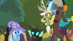 Size: 1280x720 | Tagged: safe, derpibooru import, edit, edited screencap, editor:incredibubbleirishguy, screencap, discord, thorax, trixie, changeling, draconequus, unicorn, to where and back again, backpack, bush, clothes, confused, dunno, hat, shrug, tree, trio, trixie's hat