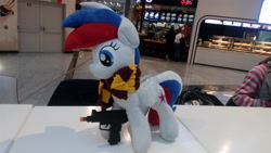 Size: 4096x2304 | Tagged: artist needed, safe, derpibooru import, oc, oc:katyusha (mascot), pegasus, pony, clothes, cyrillic, food court, gun, irl, photo, russia, russian flag, scarf, submachinegun, uzi, weapon