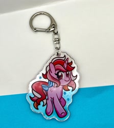 Size: 2250x2518 | Tagged: safe, artist:redpalette, derpibooru import, galaxy (g1), unicorn, g1, bow, horn, keychain, looking at you, merchandise, photo, smiling