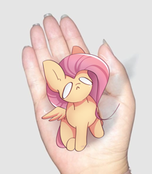 Size: 1997x2280 | Tagged: safe, artist:miryelis, derpibooru import, fluttershy, human, pegasus, pony, crying, cute, disembodied hand, full body, hand, in goliath's palm, irl, irl human, meme, micro, photo, sitting, size difference, small pony, smol, solo