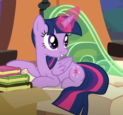 Size: 628x589 | Tagged: safe, derpibooru import, screencap, twilight sparkle, twilight sparkle (alicorn), alicorn, pony, g4, book, box, cropped, folded wings, friendship express, glowing, glowing horn, horn, locomotive, lying down, prone, smiling, solo, steam locomotive, trade ya!, train, wings
