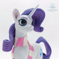 Size: 2560x2560 | Tagged: safe, alternate version, artist:lakterra, derpibooru import, rarity, pony, unicorn, g4, alternate angle, close-up, clothes, craft, female, figurine, horn, irl, mare, photo, polymer clay, scarf, signature, simple background, smiling, solo, striped scarf, tail, white background