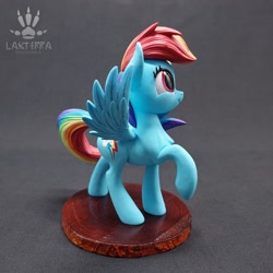 Size: 2560x2560 | Tagged: safe, alternate version, artist:lakterra, derpibooru import, rainbow dash, pegasus, pony, g4, alternate angle, craft, female, figurine, irl, looking up, mare, photo, polymer clay, raised hoof, raised leg, side view, signature, smiling, solo, spread wings, stand, tail, wings