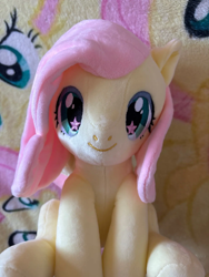 Size: 1500x2000 | Tagged: artist needed, safe, derpibooru import, fluttershy, pegasus, pony, blanket, craft, female, irl, mare, merchandise, photo, plushie, sitting, smiling, solo, spread wings, starry eyes, wingding eyes, wings