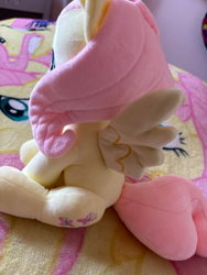 Size: 1500x2000 | Tagged: artist needed, safe, derpibooru import, fluttershy, pegasus, pony, blanket, craft, female, irl, mare, merchandise, photo, plushie, sitting, smiling, solo, spread wings, wings