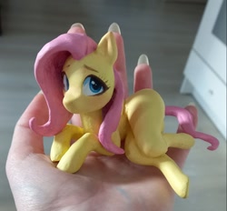 Size: 1125x1044 | Tagged: safe, artist:emysdraw, derpibooru import, fluttershy, pegasus, pony, craft, female, hand, holding a pony, irl, lying down, mare, on side, photo, sculpture, solo