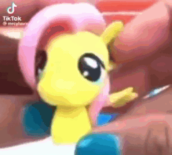 Size: 348x314 | Tagged: safe, artist:twilightburgers, fluttershy, human, pegasus, pony, animated, female, femur breaker, irl human, mare, meme, merchandise, mp4, nail polish, sound, squeeze, squeezing, squished, squishy, stretching, stretchy, toy