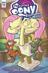 Size: 2063x3131 | Tagged: safe, artist:thom zahler, derpibooru import, idw, fluttershy, cat, pegasus, pony, g4, spoiler:comic, spoiler:comic73, behaving like a cat, cat tree, comic cover, cover, cover art, eyes closed, fluttershy's cottage, folded wings, indoors, lying down, my little pony logo, official comic, prone, tail, underhoof, variant cover, wings