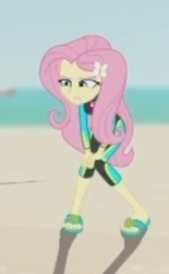 Size: 250x403 | Tagged: safe, derpibooru import, screencap, fluttershy, human, aww... baby turtles, better together, equestria girls, g4, beach, clothes, cropped, female, fluttershy's wetsuit, sandals, solo, swimsuit, wetsuit