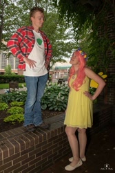 Size: 684x1024 | Tagged: safe, derpibooru import, big macintosh, fluttershy, human, 2015, brick wall, clothes, cosplay, costume, cutie mark on clothes, denim, dress, duo, duo male and female, female, floral head wreath, flower, fluttermac, hand on hip, holding hands, irl, irl human, jeans, looking at each other, looking at someone, male, pants, photo, plaid shirt, shipping, shirt, shoes, straight, t-shirt, tree, wig, wings