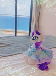 Size: 2781x3735 | Tagged: safe, derpibooru import, rarity, pony, unicorn, clothes, dress, female, horn, jewelry, mare, necklace, ocean, outfit, photo, plushie, pony plushie, princess rarity, side view, solo, water