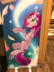 Size: 3024x4032 | Tagged: safe, artist:nadnerbd, derpibooru import, oc, oc only, oc:novella, pony, unicorn, banner, convention, convention art, cute, everfree northwest, everfree northwest 2024, female, horn, hotel room, irl, mare, ocbetes, open mouth, photo, smiling, teenager, thin