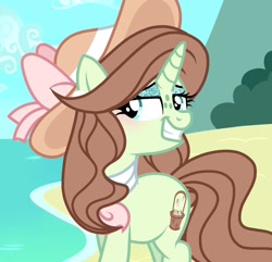 Size: 1266x1220 | Tagged: safe, artist:cstrawberrymilk, derpibooru import, oc, oc only, oc:earliglow basket, pony, unicorn, alternate hairstyle, beach, blue sky, blushing, brown mane, brown tail, day, eyelashes, eyeshadow, female, female oc, freckles, glitter, green coat, green eyes, green eyeshadow, hat, head turn, horn, lidded eyes, long mane, long tail, looking back, makeup, mare, mare oc, neckerchief, ocean, outdoors, sand, screencap background, sky, smiling, solo, sparkly eyeshadow, sun hat, tail, three quarter view, unicorn horn, unicorn oc, water, wavy mane, wavy tail