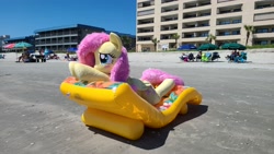 Size: 4032x2268 | Tagged: safe, artist:anonymous, artist:qtpony, derpibooru import, fluttershy, human, pegasus, pony, g4, blushing, female, fluttershy plushie, inflatable, inflatable lounge, irl, irl human, life size, mare, outdoors, photo, plushie, relaxing