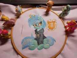 Size: 5152x3864 | Tagged: safe, artist:ambris, artist:lightdragon1988, derpibooru import, lyra heartstrings, pony, unicorn, g4, clothes, dig the swell hoodie, ear fluff, ears, embroidery, hoodie, horn, irl, lyre, magic, magic aura, musical instrument, photo, sitting, smiling, telekinesis, toy