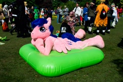 Size: 4608x3072 | Tagged: safe, artist:atalonthedeer, derpibooru import, firefly, g1, connichi, fursuit, inflatable mattress, lying down, mattress, outdoors, photo, ponysuit, prone, solo focus