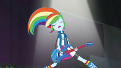 Size: 828x465 | Tagged: safe, derpibooru import, screencap, rainbow dash, human, equestria girls, g4, rainbow rocks, arms, awesome as i want to be, clothes, collar, compression shorts, cute, dashabetes, electric guitar, eyelashes, eyes closed, female, feminism, fingers, guitar, hand, holding, indoors, legs, long hair, musical instrument, open mouth, open sweatshirt, playing, playing guitar, rainbow dash is best human, rainbow sass, sass, shirt, short sleeves, singing, skirt, spotlight, standing, sweatshirt, t-shirt, teenager, teeth, windswept hair, wristband